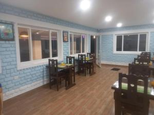 a dining room with tables and chairs in a restaurant at Elevate Ooty in Ooty