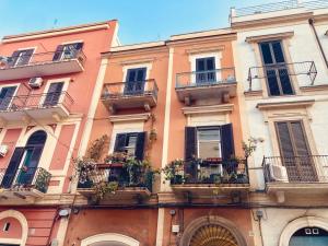a building with balconies and plants on it at At Home - Luxury apartment Bari in Bari