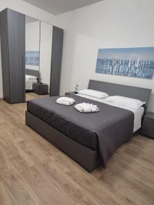 Ένα ή περισσότερα κρεβάτια σε δωμάτιο στο Porto Antico Apartment