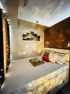 a bedroom with a large white bed with two pillows at Staycation at Eastbay in Manila