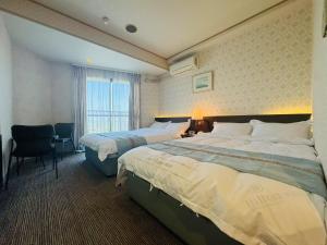 Ένα ή περισσότερα κρεβάτια σε δωμάτιο στο JUN Resort Hotel