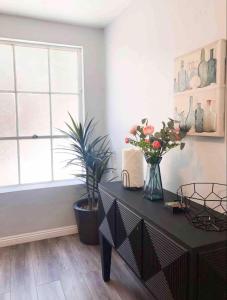 a room with a table with flowers and a window at 2bdrm Gaslamp Conv Cntr - W Parking & 5 Beds #3 in San Diego +7 photos
