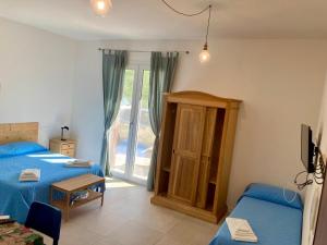 a room with two beds and a table and a window at Villa Dinesh in Sottomarina