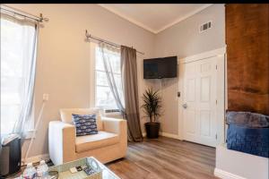 a living room with a chair and a tv at Free Parking Cozy 1BR in Gaslamp Conv Center in San Diego