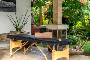 a black table and chairs in a yard at Tropical Villa Matahari - 500sqm private Garden Retreat with large Pool! in Uluwatu +35 photos