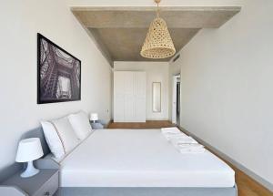 a bedroom with a white bed and a chandelier at Beautiful Modern 1bd Condo Views W Poolgym! #223 in Istanbul +19 photos