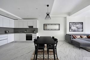 a kitchen and living room with a table and a couch at Beautiful Modern 1bd Condo Views W Poolgym! #223 in Istanbul