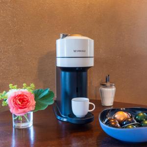 a coffee maker sitting on a table next to a bowl of balls at Ferienappartement Enzianshaus in Höchheim +46 photos