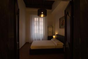 a small bedroom with a bed and a window at Michelangelo Escape Suite in Pietrasanta
