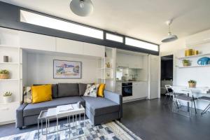 a living room with a couch and a table at Bright Modern Design New Duplex Loft Patio! #145 in Istanbul