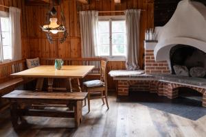 a dining room with a table and a fireplace at Landhaus Danner in Goldwörth