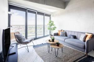 a living room with a couch and a tv at Gorgeous Modern 1bd Condo Views W Poolgym! #255 in Istanbul