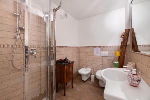 a bathroom with a shower and a sink and a toilet at Villa Alessandra in Pellio Inferiore +31 photos