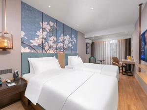 Ένα ή περισσότερα κρεβάτια σε δωμάτιο στο Magnotel Classic Shenyang General Hospital of Northern Theater Command +224 φωτογραφίες