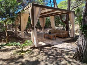 a pavilion with a couch on a wooden deck at GallyBi in Gallipoli