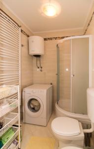 a bathroom with a washing machine and a toilet at Apartment Peran in Šibenik
