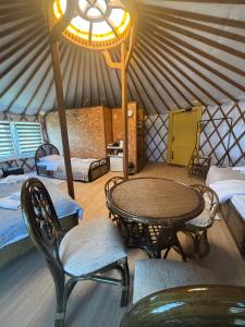 a room with a table and chairs in a yurt at Brzozowy Zagajnik in Inwałd +10 photos