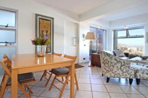 a living room with a dining room table and a couch at Camps Bay Terrace Suite in Cape Town