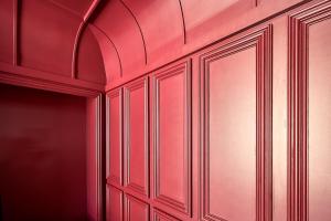a room with red walls and wooden cabinets at The Vinea Collection Hotel by Piamonte Hotels in Monção