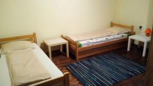 a small bedroom with two beds and a rug at Country cottage 