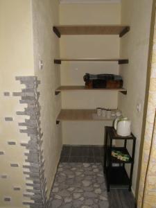 a hallway with a wall with shelves and a table at Country cottage 