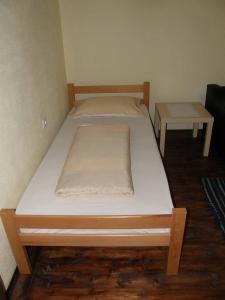 a bed in a room with two tables on it at Country cottage  +3 photos