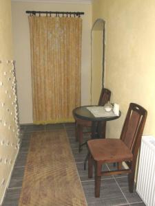 a dining room with a table and two chairs at Country cottage 