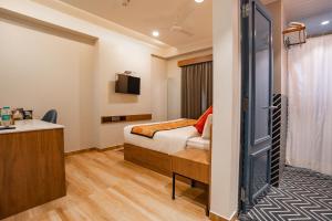 a hotel room with a bed and a desk at Hotel Lake Metro in Udaipur
