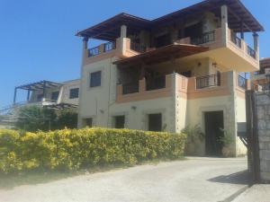 a building with a balcony on top of it at Nikos Studio in Kalyves
