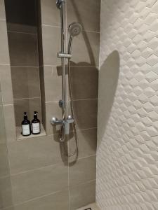 a shower with a shower head in a bathroom at QUILL RESIDENCE KUALA LUMPUR CITY By AZMILA EMPIRE in Kuala Lumpur