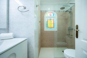 a bathroom with a shower and a toilet and a window at Ca'n Miquel in Colonia de Sant Pere +23 photos