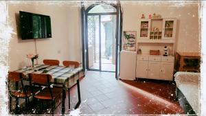 a kitchen with a table and chairs in a room at Gioia Montedoro in Viareggio
