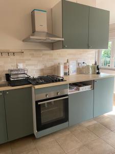 a kitchen with a stove and a counter top at Vendégház a diófához in Balatonboglár