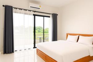 a bedroom with a bed and a large window at Sawaddee Pua Homestay(Cozy Home) in Pua +2 photos
