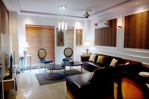 a living room with a couch and a table at 116 Apartments Luxestay CBD in Lahore
