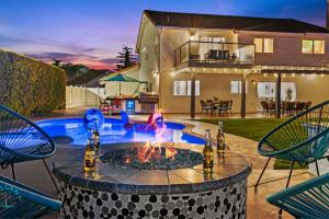 a fire pit in the middle of a yard with chairs at SoCal Gem Pool, Spa, Games, and Scenic Views in Oceanside