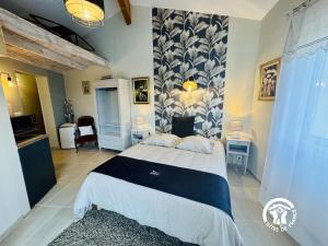 a bedroom with a large bed in a room at La cazabanelle in Villegly