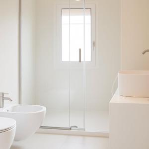a white bathroom with a sink and a toilet at Bianco d'Alghero - apartment by the sea in Alghero +12 photos