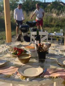 a table with plates of food and a bottle of wine at Wonderful summer place in beautiful Köpingsvik, Borgholm in Köpingsvik