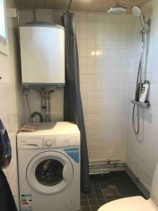 a small bathroom with a washing machine in it at Wonderful summer place in beautiful Köpingsvik, Borgholm in Köpingsvik