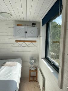 a small bedroom with a bed and a window at Wonderful summer place in beautiful Köpingsvik, Borgholm in Köpingsvik