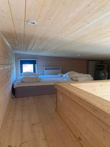 a room with two beds in a wooden room at Wonderful summer place in beautiful Köpingsvik, Borgholm in Köpingsvik