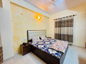 a bedroom with a bed with a quilt on it at shree dhaam Vrindavan in Vrindāvan