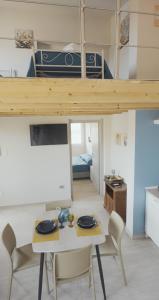 a room with a table and chairs and a bunk bed at Mhometredici Guest House in Sestu