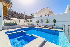 Casa Roque del Mar Private Villa with Heated Saltwater Pool, Jacuzzi & Ocean Views في أديخي: حمام سباحة في الفناء الخلفي للمنزل