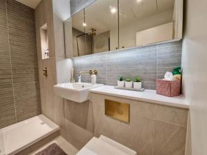 a bathroom with a sink and a mirror at Wembley Cozy Cloud Waterfront Retreat with Parking near Wembley stadium in London +41 photos