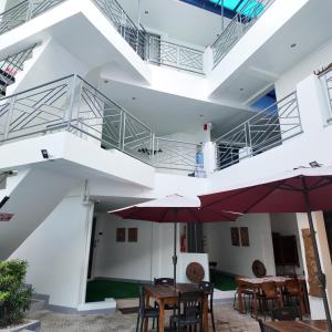 a patio with tables and umbrellas in a building at El Puerto Boracay Shore in Boracay