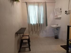 a bathroom with a sink and a stool and a window at Ingna Resort in Chanuman +73 photos