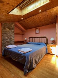 a bedroom with a bed in a room with wooden ceilings at Las Bodegas De Claveria in El Humo de Muro
