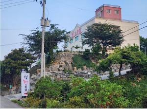 a building on a hill with a building on it at Star Spa Hotel in Haenam